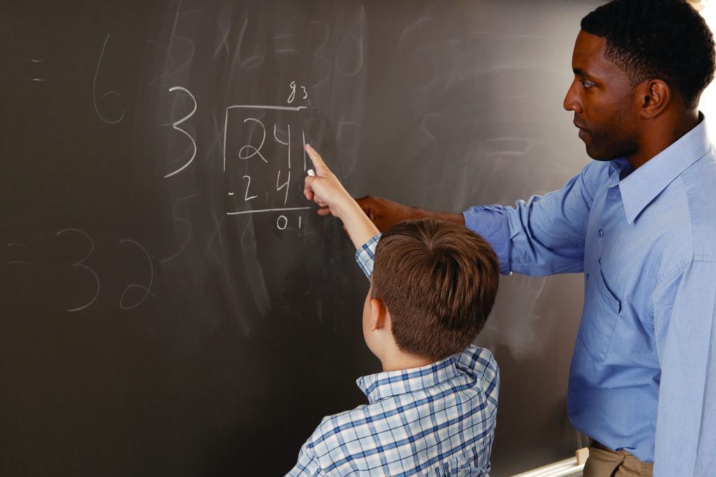 Teacher helping student with math problem